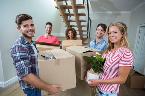 Removal team sorting recyclable materials during a sustainable house move in Kingston upon Thames