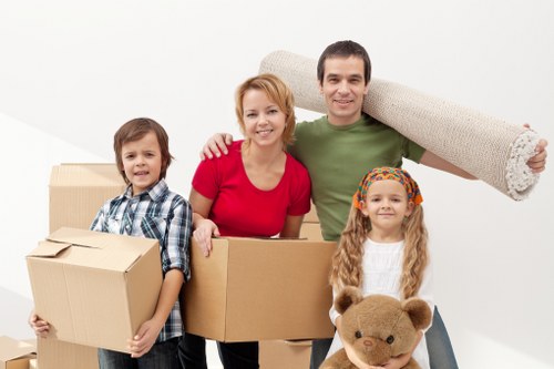 Worker using moving equipment to handle furniture safely