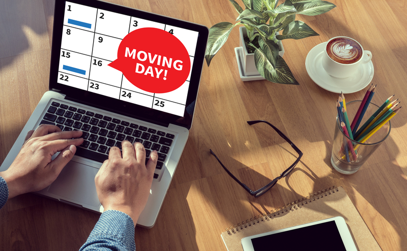 Commercial movers handling office furniture in a Kingston street